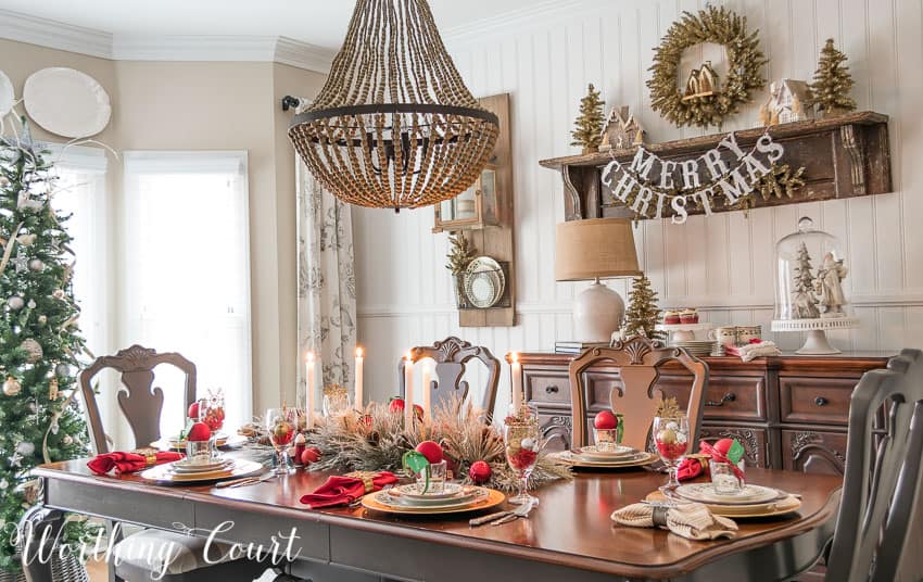 There is a beaded chandelier above the dining room table.