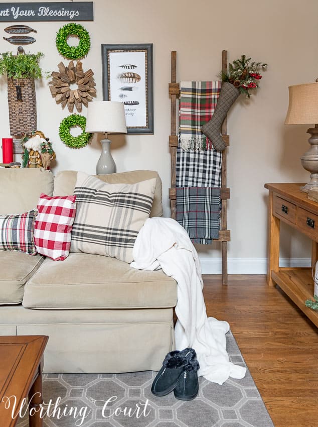 DIY rustic ladder with a variety of plaid Christmas throws in the family room.