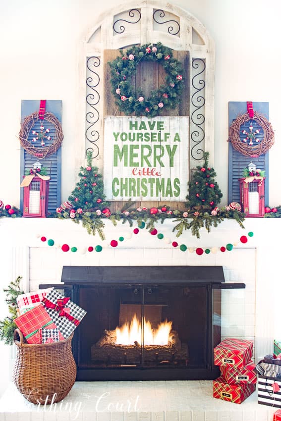 Merry Christmas farmhouse mantel a sign that says Have Yourself A Merry Little Christmas.