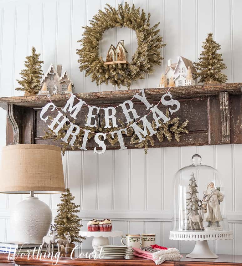 Merry Christmas vignette on a wooden shelf.