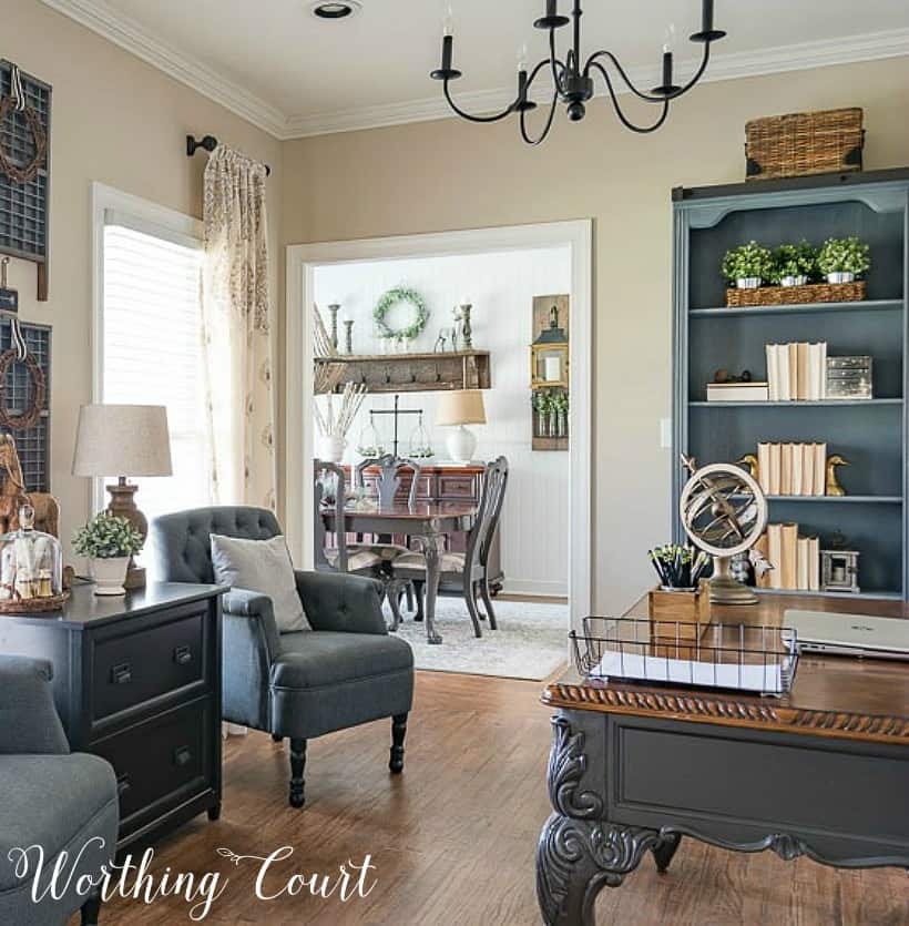 Home office with gray chairs, gray bookcases and desk.