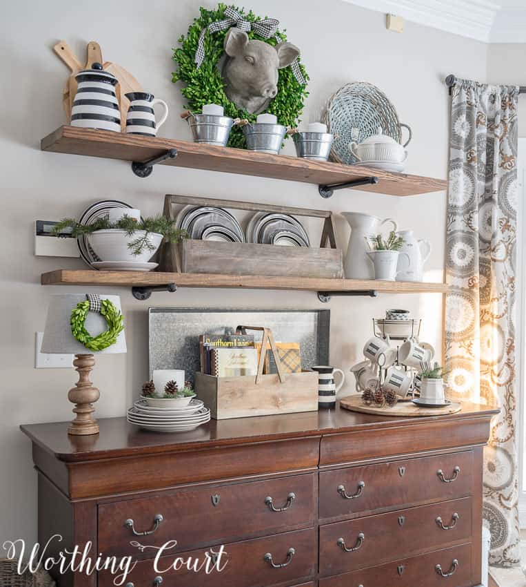 Open rustic industrial shelves with winter decor.