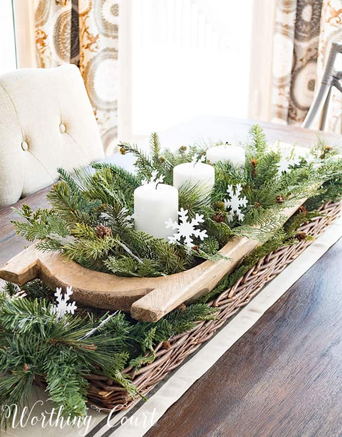 Super easy and fast winter centerpiece in a dough bowl with candles and little snowflakes.