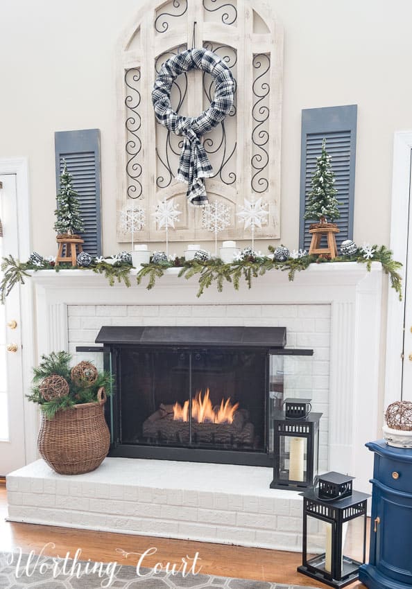 My Snowy Winter Fireplace decor with faux mini trees, snowflakes and the winter wreath.