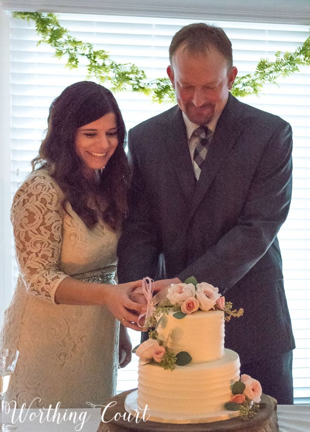 Wedding cake cutting by candlelight.