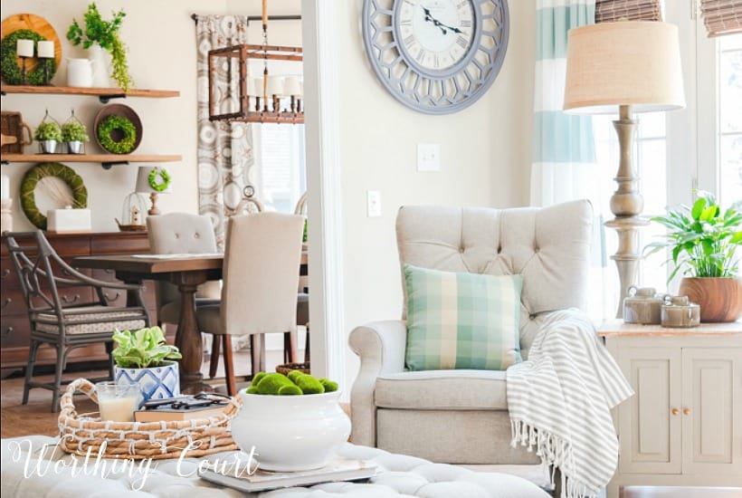 Neutral accent chair with pillow and throw.