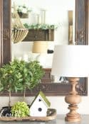 spring vignette with greenery and a birdhouse