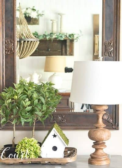 spring vignette with greenery and a birdhouse