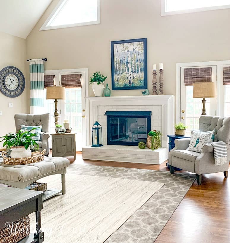 family room with white brick fireplace flanked by gray recliners