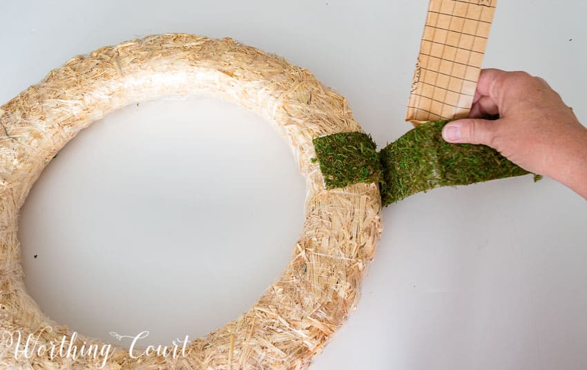 Wrapping the moss around the wreath form.