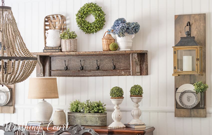 dining room with a planked wall, diy hanging lanterns and a vintage mantel turned into a display shelf 