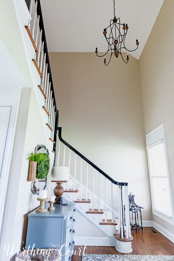 Blank stairway wall with tall ceilings.