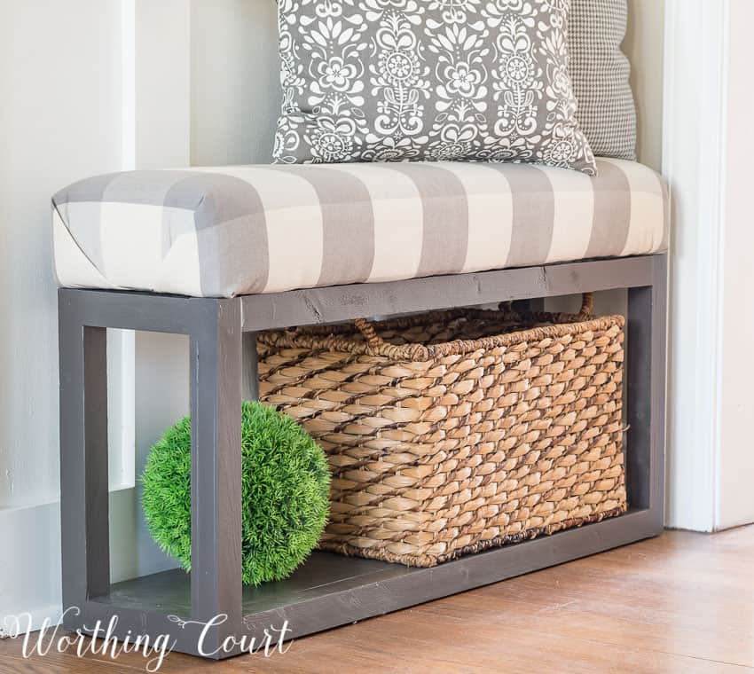 A woven basket is underneath the bench.