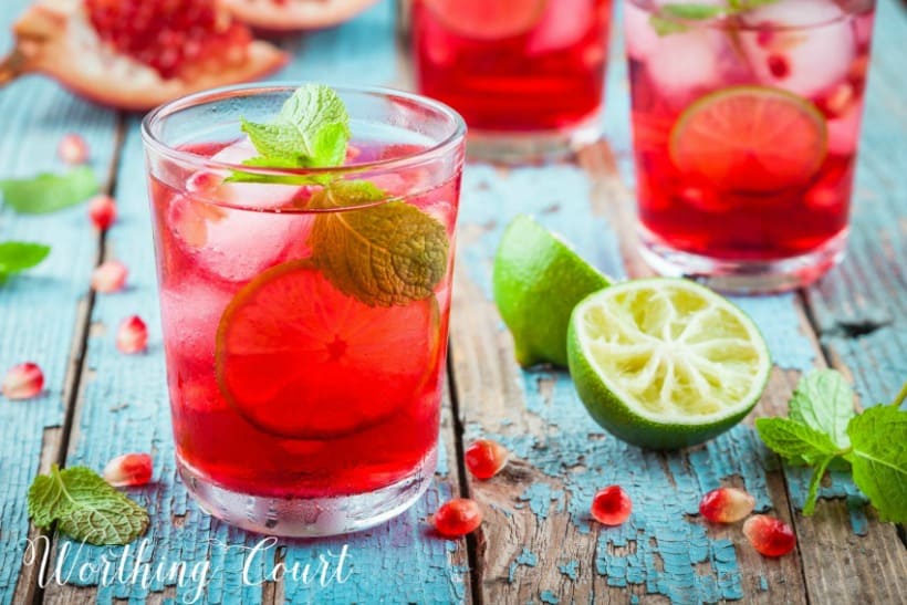 Glass of pomegranate lemonade and mint leaves.