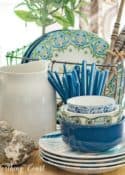 centerpiece with blue white and green dishes on a breadboard