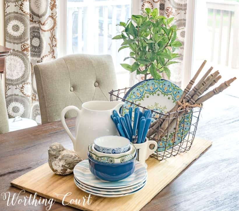 Blue and white bowls and plates, plus a wooden cutting board.