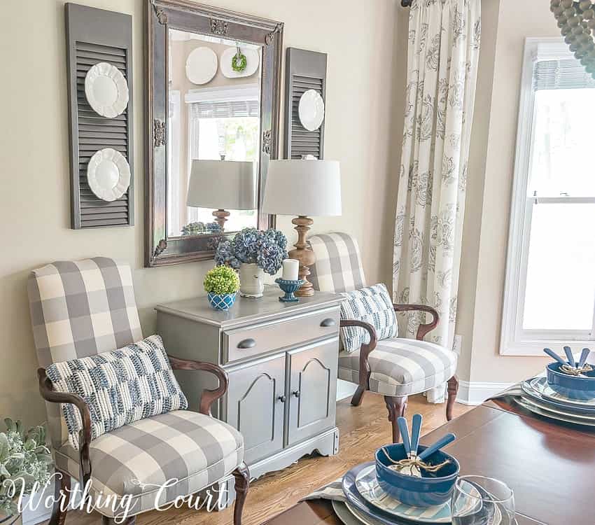 There are two armchairs in grey and white just off the dining room.