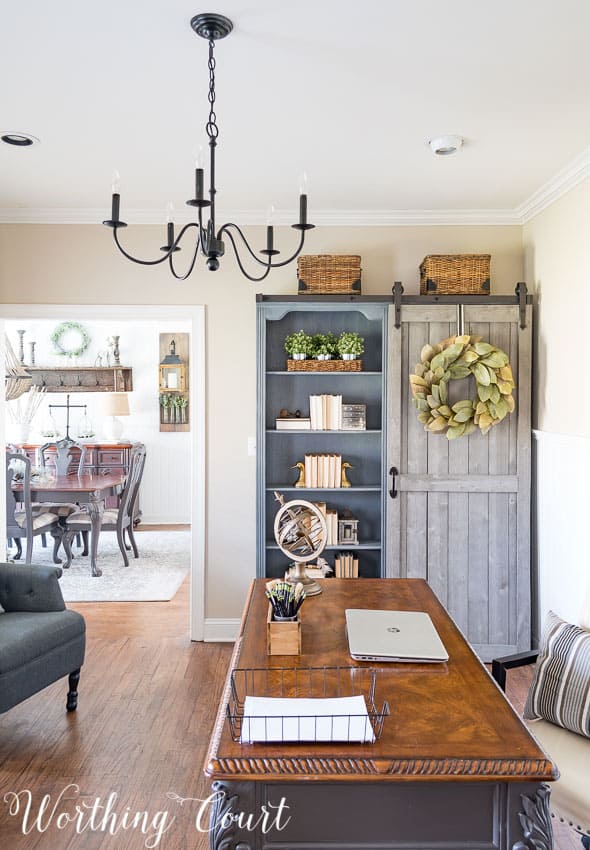 Gray bookcase with diy sliding farmhouse door.