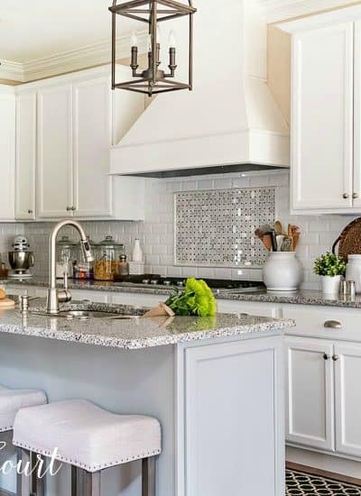 kitchen with white shaker cabinets and a gray island