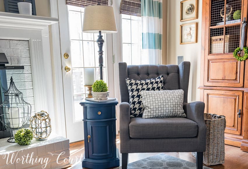 Cozy corner with a gray tufted chair, blue side table and floor lamp || Worthing Court