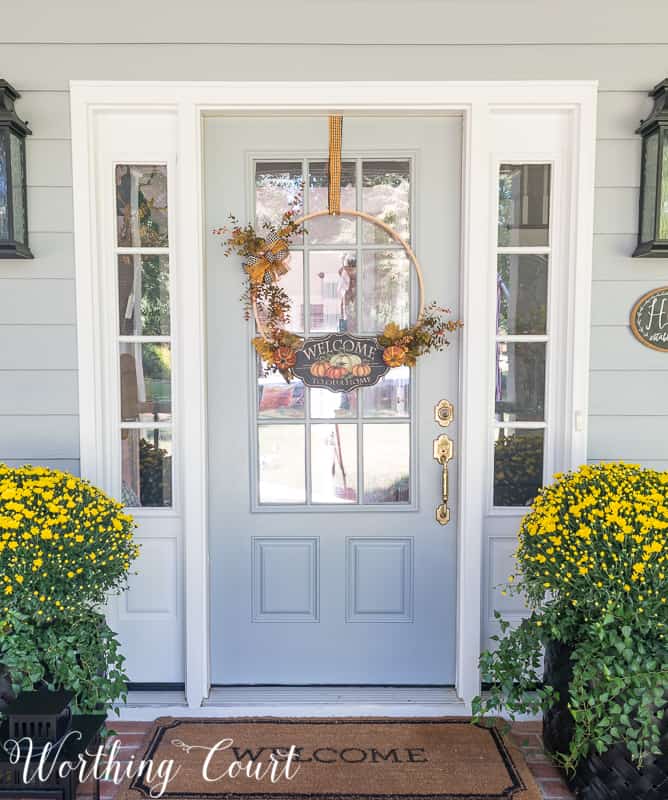 Easy diy fall embroidery hoop wreath hanging on the front door.