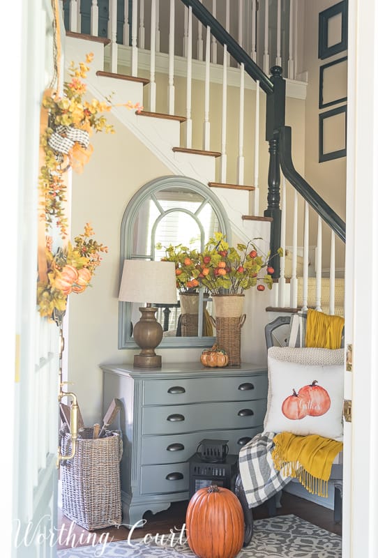 Fall foyer decor with traditional autumn colors.