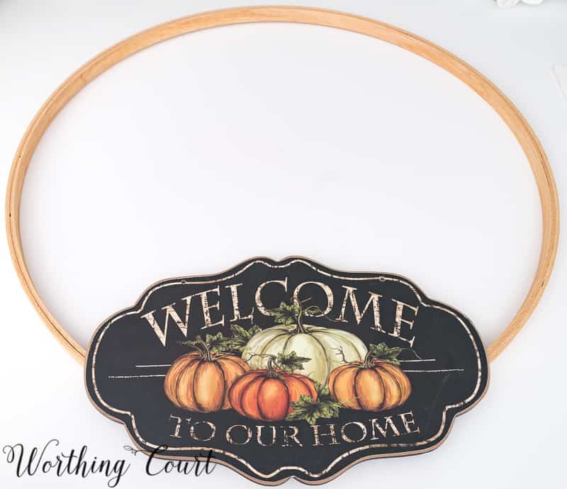 Attaching the Welcome To Our Home sign on the hoop.