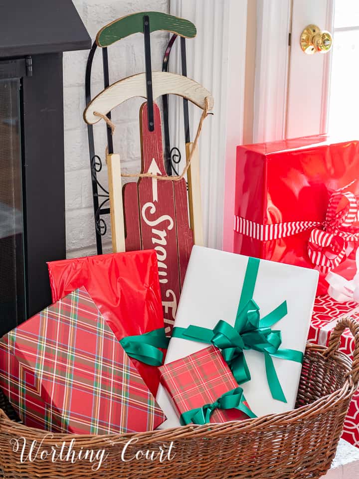 Wicker basket filled with wrapped gifts.