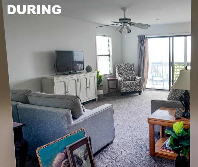 The same living room with new couch in neutral color and new armchair.