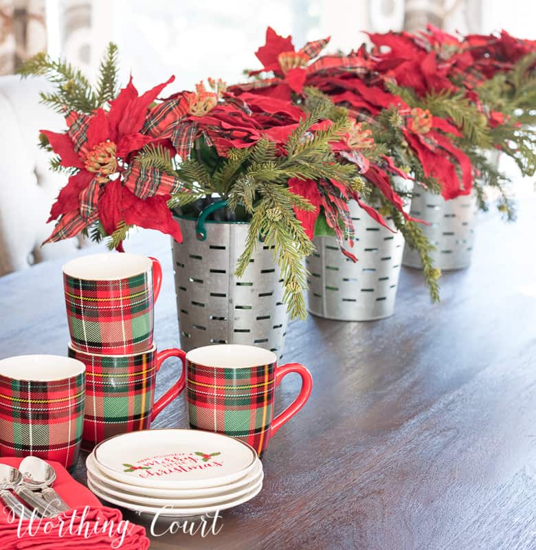 Simple Christmas centerpiece with faux poinsettias in galvanized buckets #christmas #christmascenterpiece #poinsettias #plaid