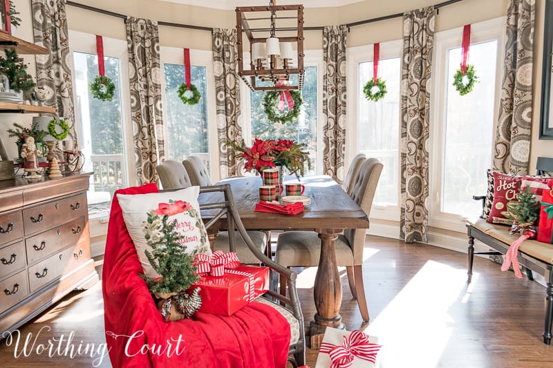 Christmas wreaths suspended with plaid ribbon in a bay window #christmas #christmasdecor #christmaswreath #tartanplaid