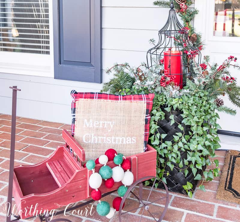 Christmas outdoor container filled with a pillow and christmas baubles.