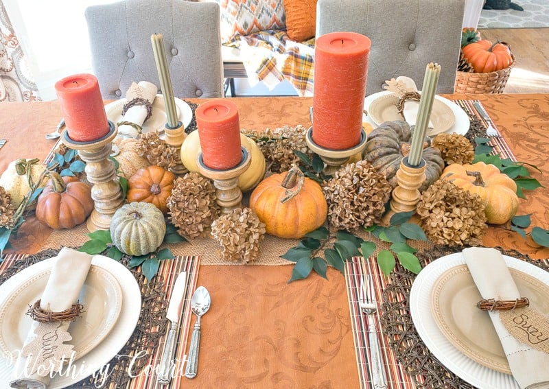 A gold tablecloth with plates on the table.