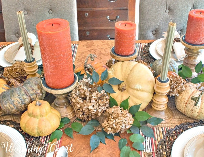 Use a mixture of candles and candlesticks for an elegant Thanksgiving centerpiece.