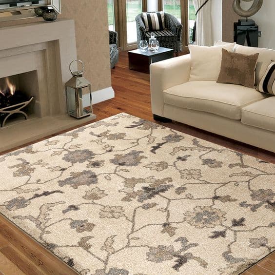 American Heritage - Tantum Lambswool with a vine floral pattern in front of a fireplace.