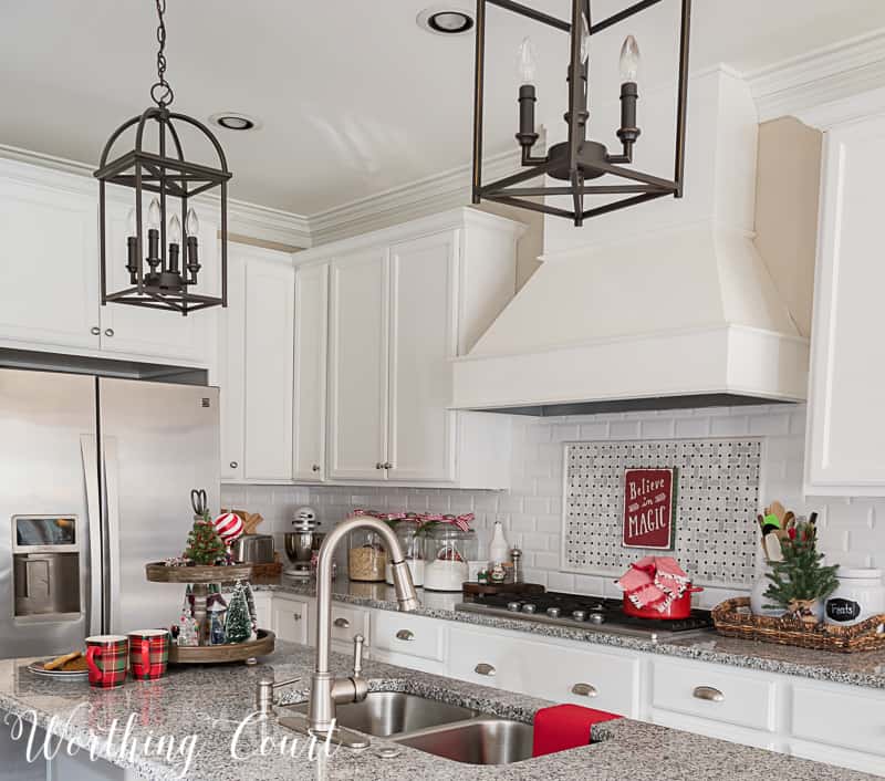 Farmhouse kitchen with white cabinets decorated for Christmas.