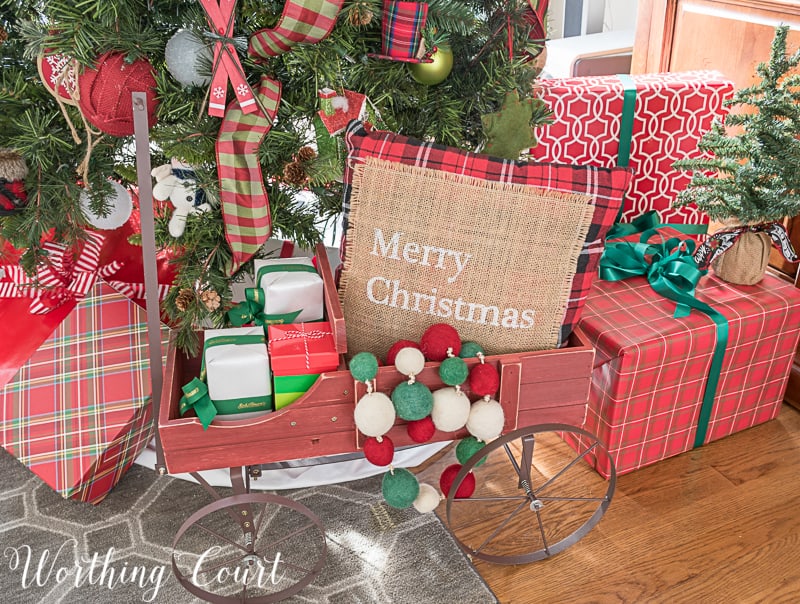 Small wagon under a Christmas tree makes a cute holder for wrapped gifts #Christmasdecor