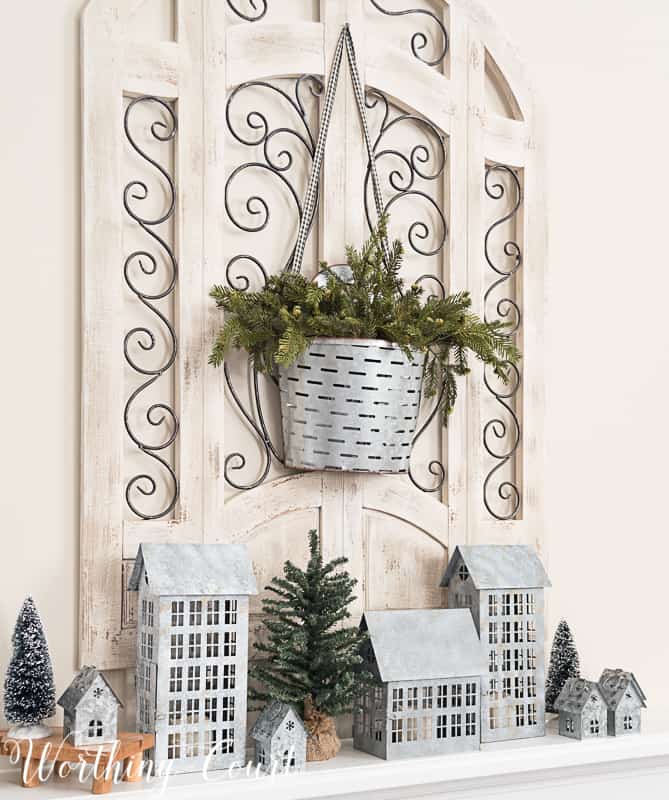 galvanized metal container, olive bucket, winter decor on the fireplace mantel.
