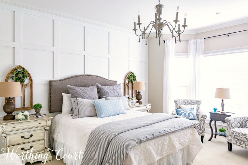 Bedroom with a chandelier over top of the bed.