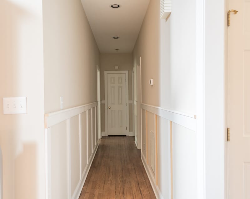 The long hallways painted a bright white and the carpet removed.