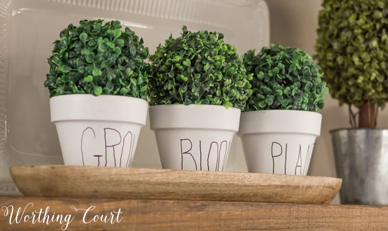 Rae Dunn lookalike clay pots in white with Grow, Bloom, Plant on them.