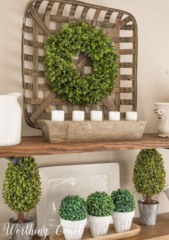 Open shelves with spring decorations in green and white.