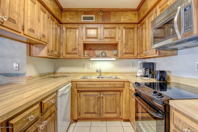 A small kitchen with wooden cabinets.