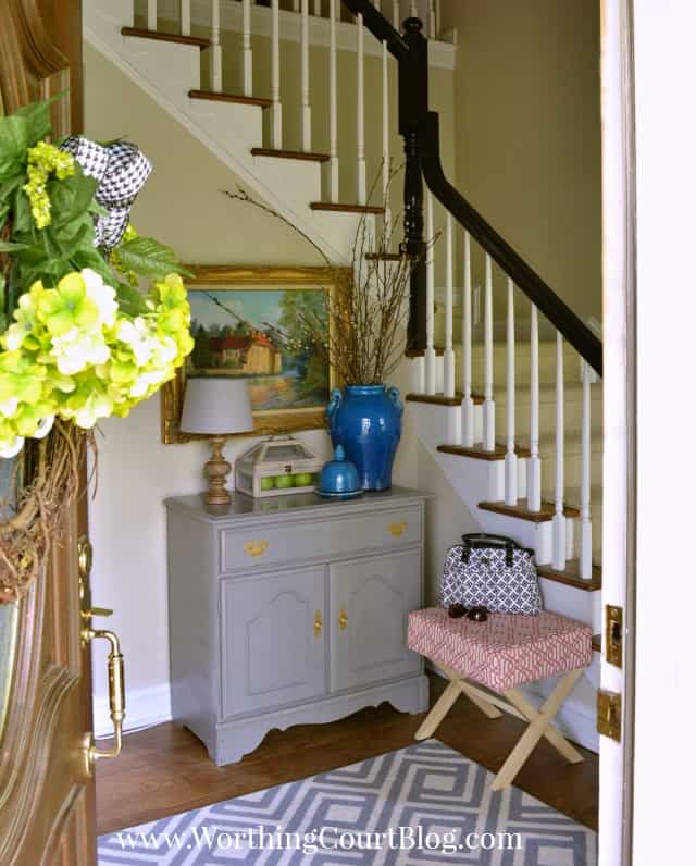 Foyer BEFORE makeover with a blue vase on a side table.