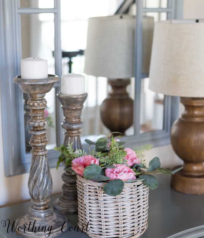 Foyer vignette with pink roses and gray candlesticks.