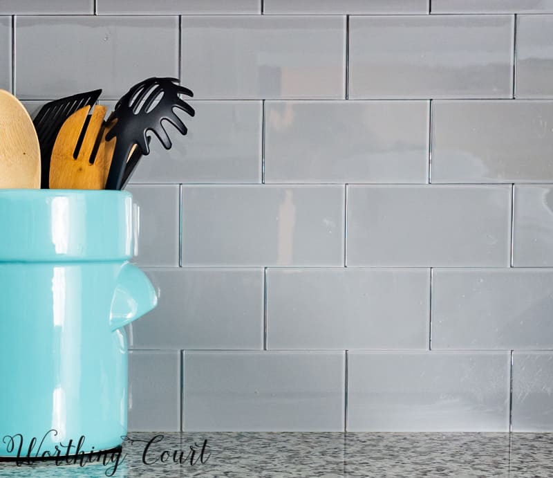 A blue canister holding untensils on the counter.