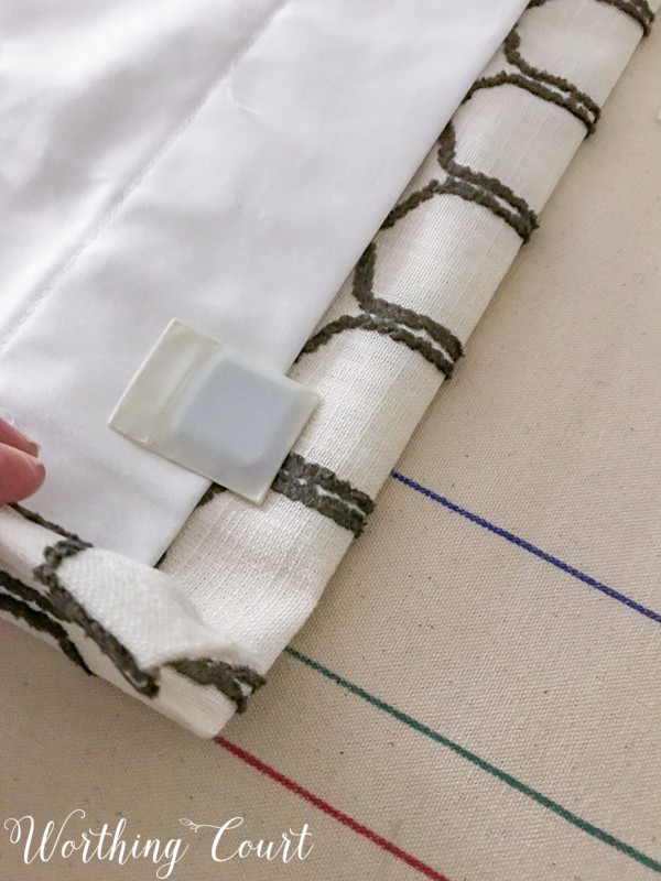 How To Make A Lined, Flat Drapes Just Like The Pros Do - It's Easy! Use a drapery weight in the bottom corner of each panel. #drapesforlivingroom #curtains #draperies #draperypanels #diydrapes #diycurtains #drapetechniques #drapesforslidingglassdoors #windowdrapes