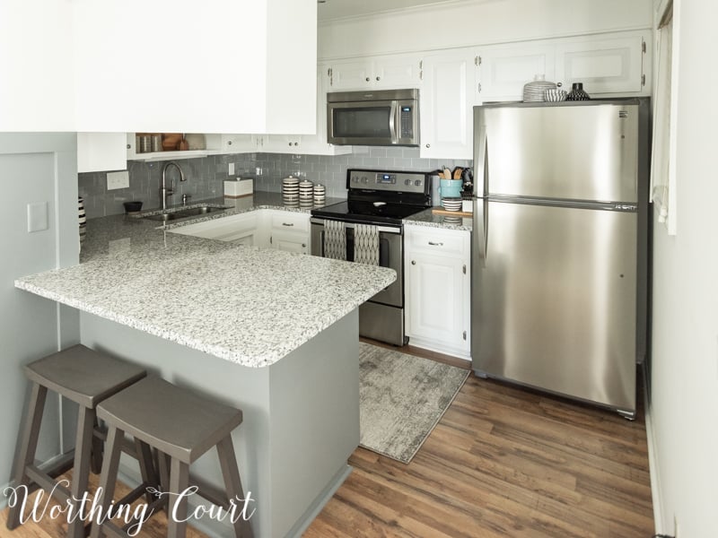 The same kitchen with white cabinets and counters.