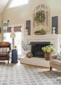 Oversized wood art above a fireplace in a room with a vaulted ceiling. #farmhousestyle #paintedfireplace #brickfireplace #fireplacmakeover #manteldecoratingideas #springdecor