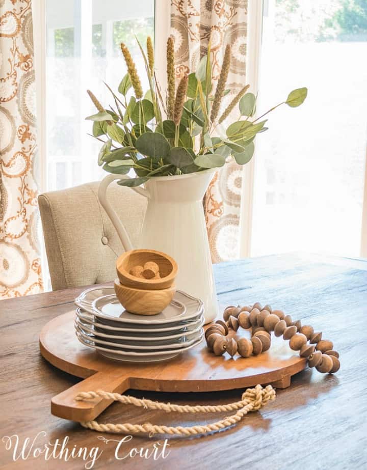 A wooden bread board with plates on it.